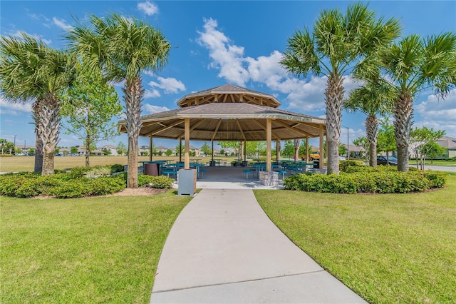 surrounding community with a gazebo and a yard