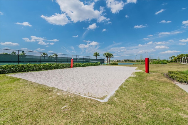 view of home's community featuring volleyball court and a lawn