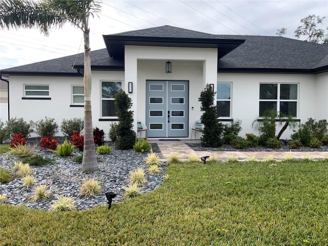 view of exterior entry with a lawn