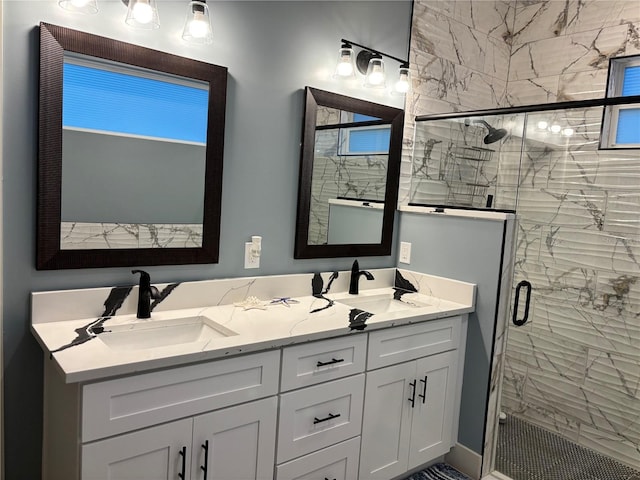 bathroom with vanity and a shower with door