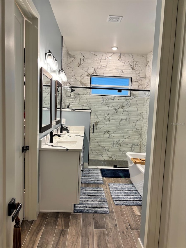 bathroom featuring vanity and plus walk in shower