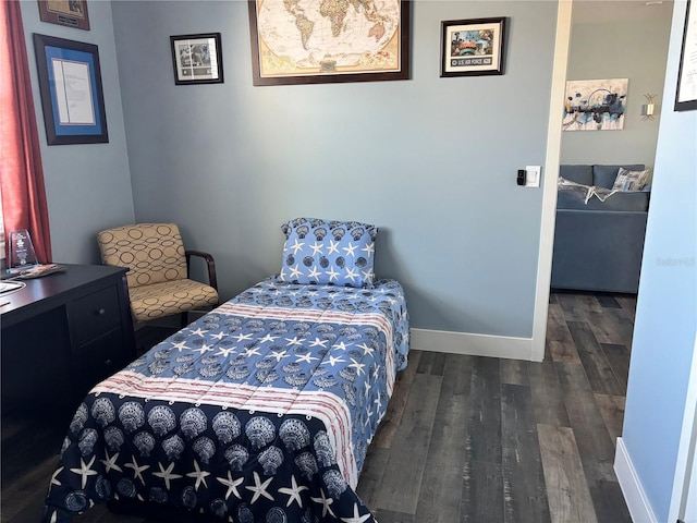 bedroom with dark hardwood / wood-style flooring