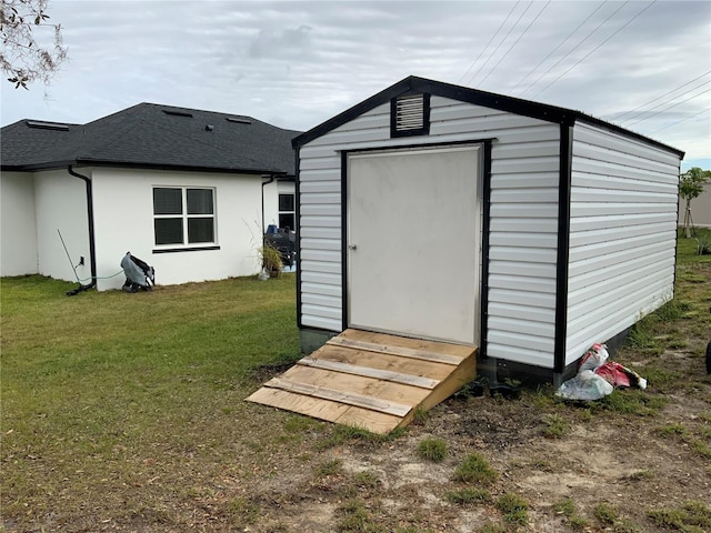 view of outbuilding featuring a lawn