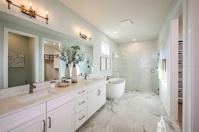 bathroom featuring marble finish floor, a sink, and a shower stall