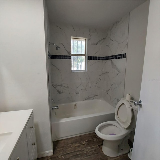 full bathroom with hardwood / wood-style floors, vanity, toilet, and tiled shower / bath combo