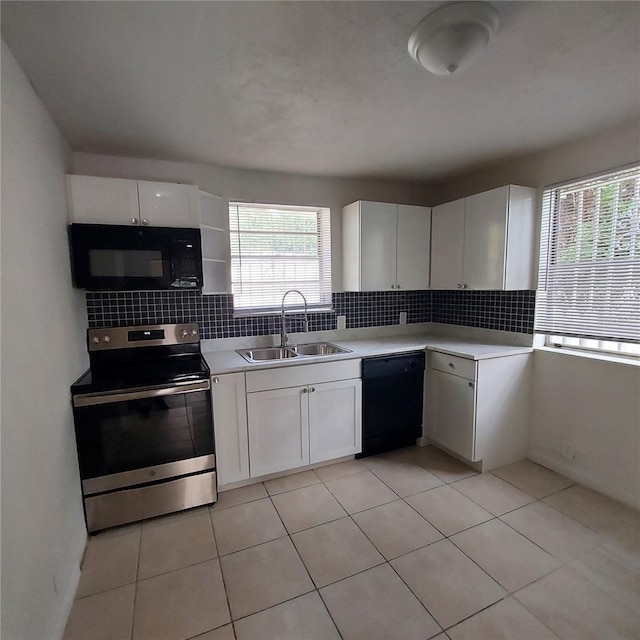 kitchen with backsplash, sink, stainless steel stove, black dishwasher, and white cabinetry