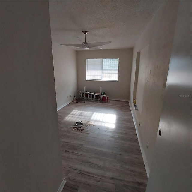 empty room featuring wood-type flooring and a textured ceiling