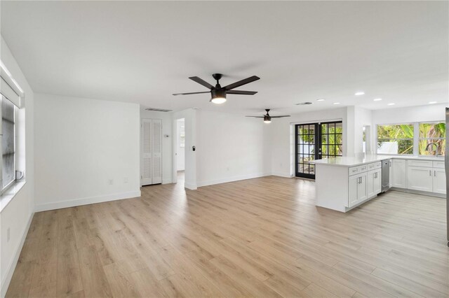 unfurnished living room featuring french doors, ceiling fan, light hardwood / wood-style flooring, and wine cooler