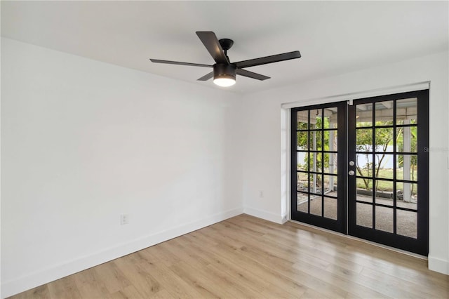 empty room with light hardwood / wood-style flooring, french doors, and ceiling fan