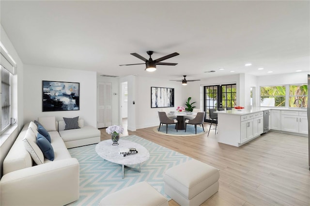 living room with wine cooler and light hardwood / wood-style floors