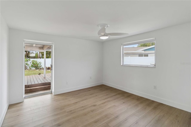 spare room with ceiling fan and light wood-type flooring