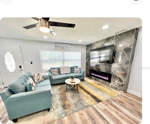 living room featuring ceiling fan and hardwood / wood-style floors