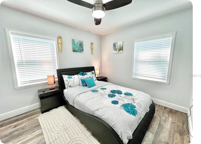 bedroom featuring hardwood / wood-style flooring and ceiling fan