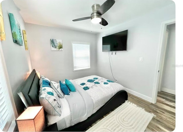 bedroom with hardwood / wood-style flooring and ceiling fan