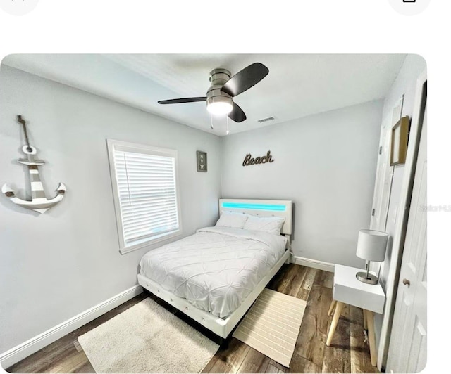 bedroom featuring dark hardwood / wood-style flooring and ceiling fan