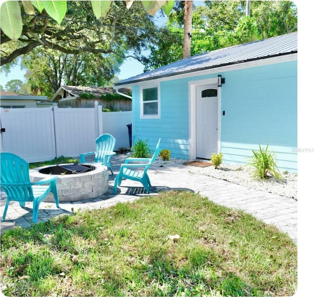 view of yard featuring an outdoor fire pit and a patio area