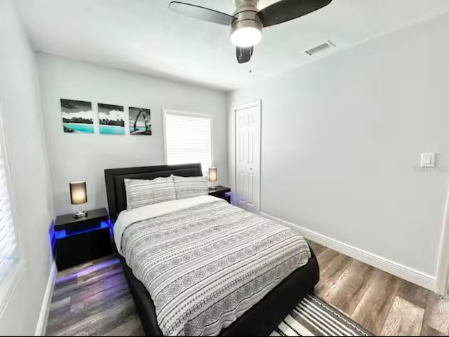 bedroom featuring ceiling fan, a closet, and dark hardwood / wood-style floors