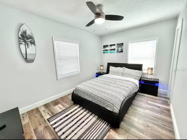 bedroom with light hardwood / wood-style floors and ceiling fan