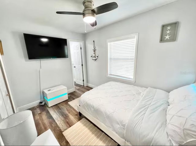 bedroom featuring ceiling fan and dark hardwood / wood-style floors