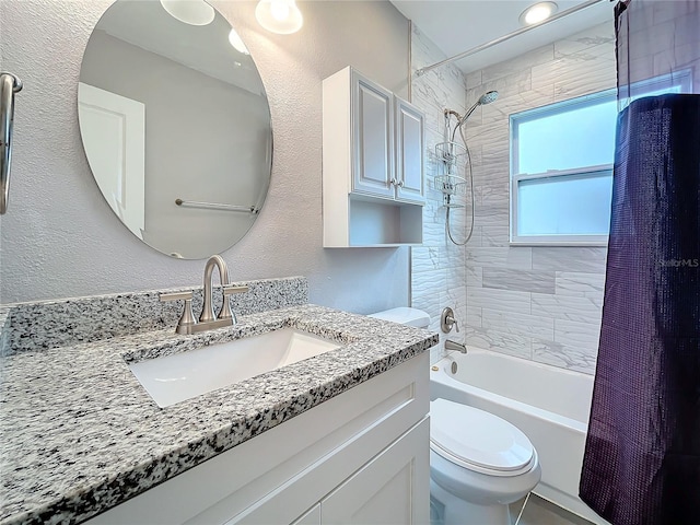 full bathroom with toilet, vanity, and shower / tub combo with curtain