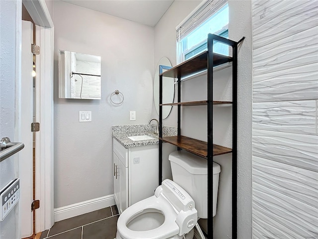 bathroom with toilet, tile patterned flooring, and vanity