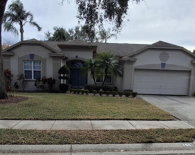 single story home featuring a garage and a front yard