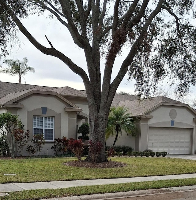 single story home featuring a front yard and a garage