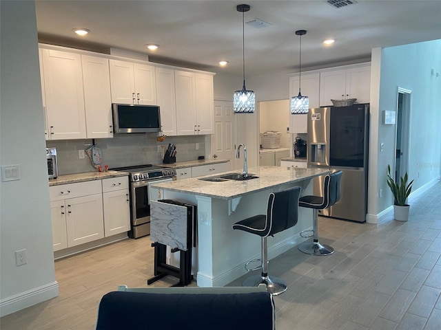 kitchen featuring sink, white cabinets, and appliances with stainless steel finishes