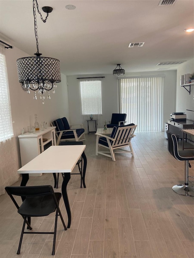 dining room with a healthy amount of sunlight and light hardwood / wood-style flooring