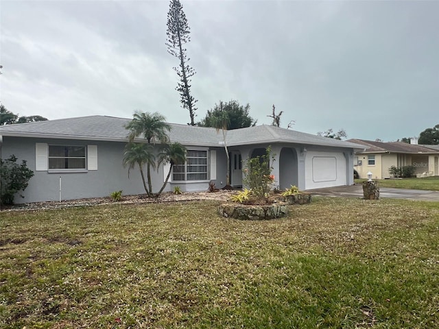 single story home featuring a garage and a front lawn