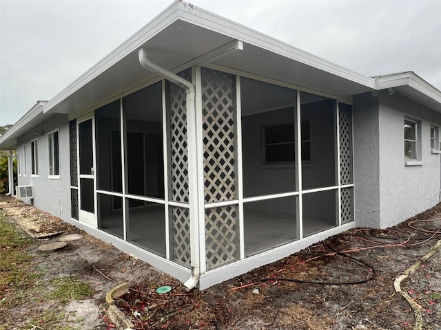 view of side of home with a sunroom