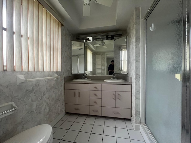 bathroom featuring walk in shower, toilet, vanity, ceiling fan, and tile patterned flooring