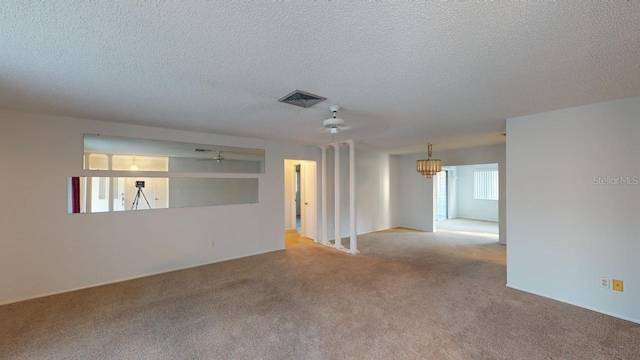 carpeted spare room with a textured ceiling