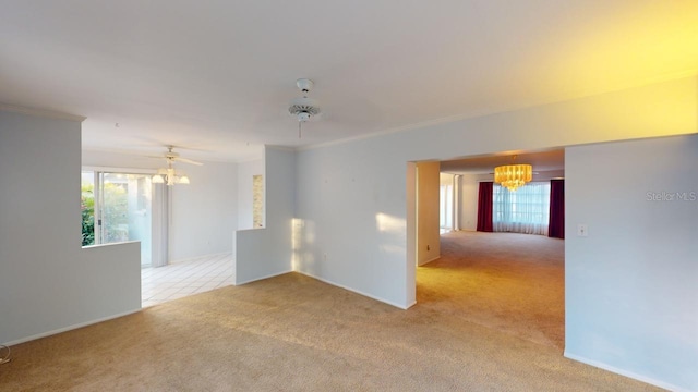 unfurnished room featuring crown molding, ceiling fan with notable chandelier, and light carpet