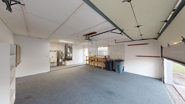 garage with a garage door opener, electric water heater, and heating unit