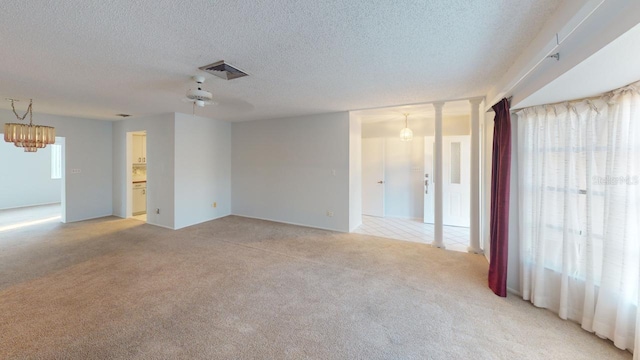 carpeted spare room featuring a textured ceiling