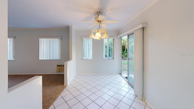 carpeted empty room with radiator, ceiling fan with notable chandelier, and ornamental molding