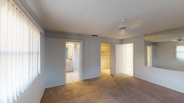 unfurnished room with light carpet and a textured ceiling