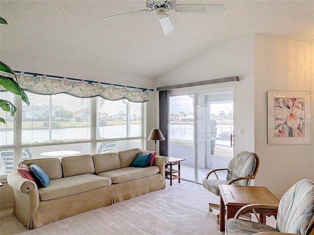 living room with ceiling fan, lofted ceiling, light carpet, and a textured ceiling