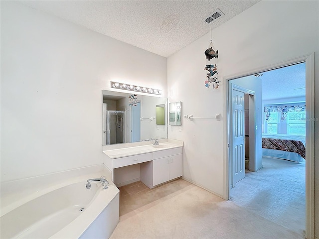 bathroom featuring vanity, shower with separate bathtub, and a textured ceiling