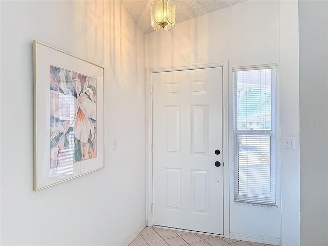 entryway featuring light tile patterned flooring and a textured ceiling