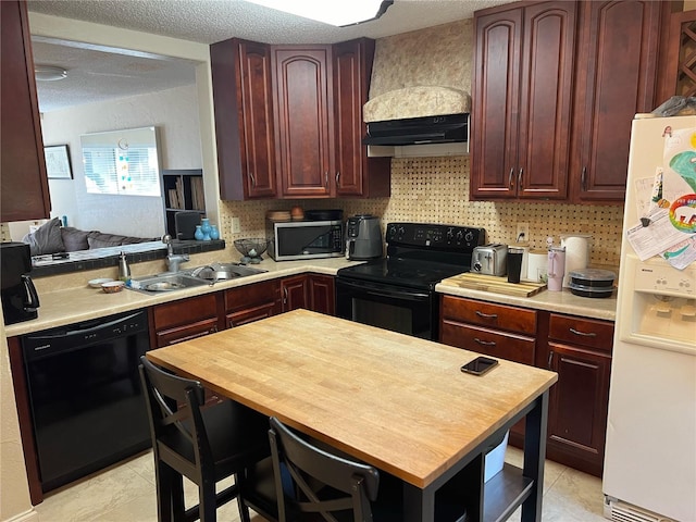 kitchen with premium range hood, light tile patterned flooring, sink, a textured ceiling, and black appliances