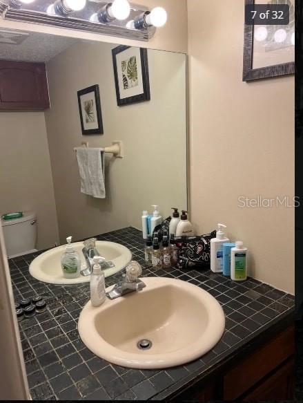 bathroom featuring vanity and toilet