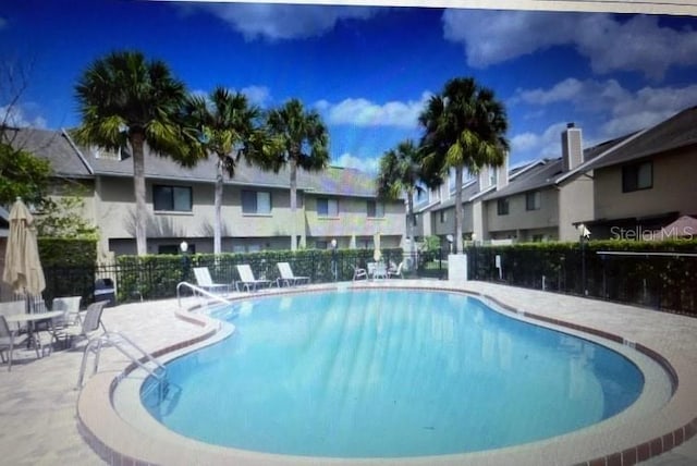 view of swimming pool with a patio area