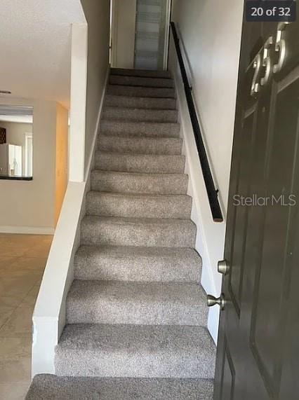 stairs with tile patterned flooring