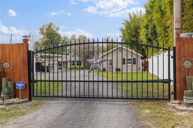 view of gate featuring a lawn