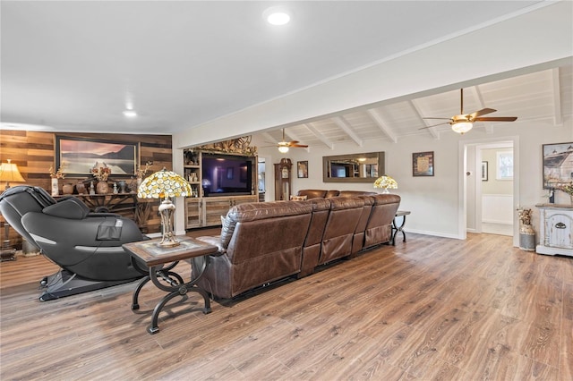 living room with ceiling fan, lofted ceiling with beams, and hardwood / wood-style floors