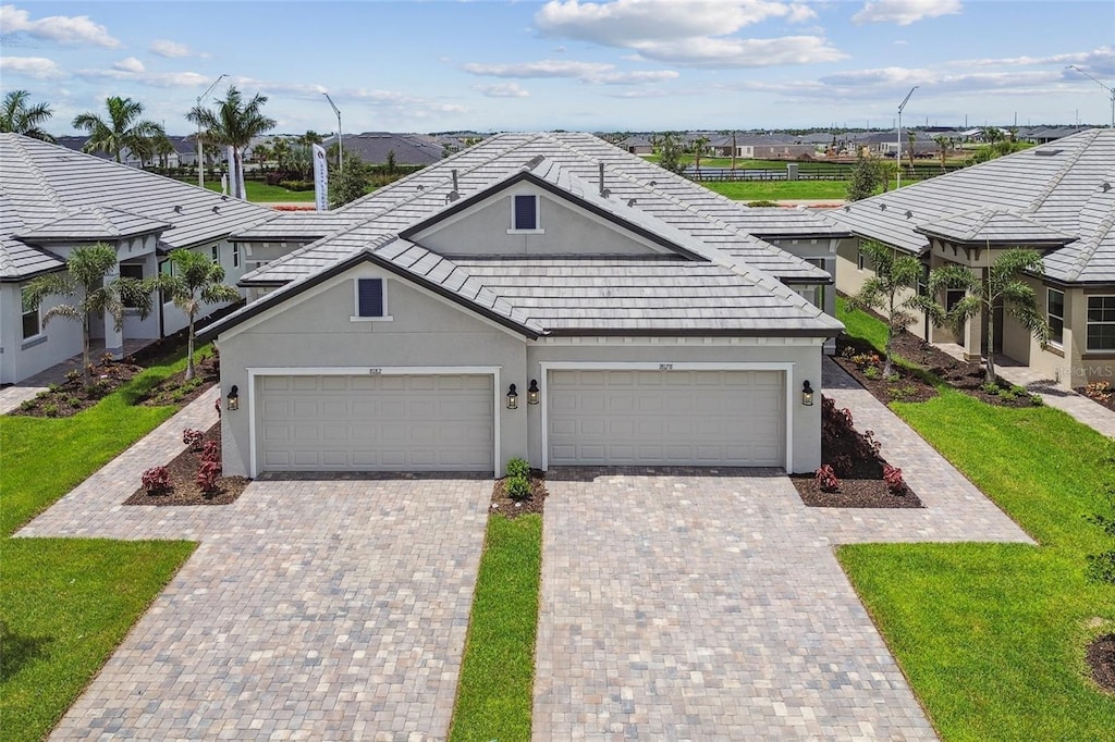 view of front of home with a garage and a front lawn