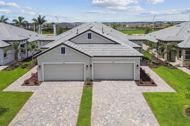 view of front of home with a garage and a front lawn