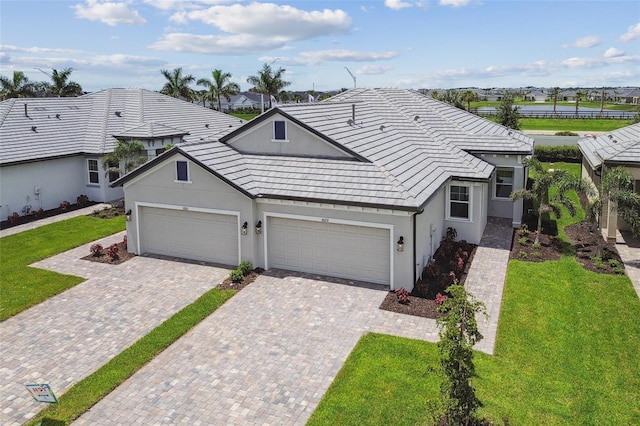 ranch-style home featuring a garage and a front lawn